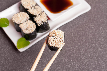 Sushi with sesame on a white plate, close up, horizontalの写真素材