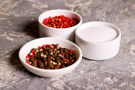 assortment of pepper and salt in bowls, closeup
