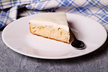 Sweet pie with sour cream on a white plate, close up, horizontalの写真素材