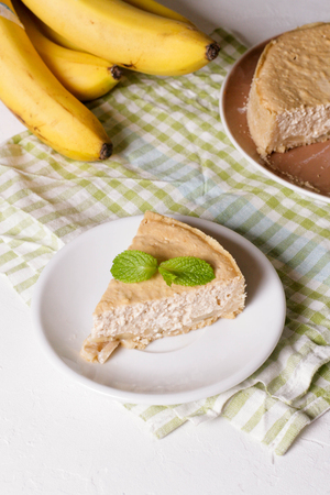 Banana cream pie on a white plate, close up, verticalの写真素材