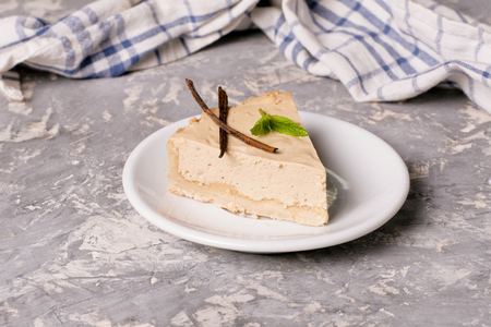 Caramel cheesecake (New York cheesecake) on white plate, close up, horizontalの写真素材