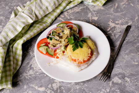 Fish baked with cheese and tomatoes, close up, horizontal, top viewの写真素材