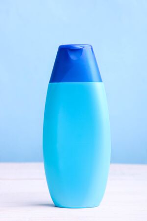 Blue bottle with shampoo or shower gel on blue background. Copy space.の写真素材
