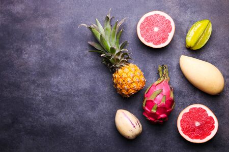 Ripe exotic fruits on a black background.の写真素材