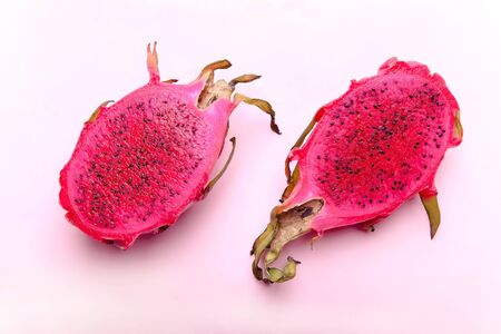 Ripe red half of pitahaya on a pink background.の写真素材