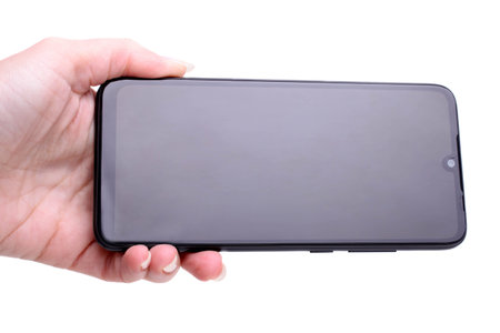 Modern smartphone in a female hand isolated on white. Technology concept.