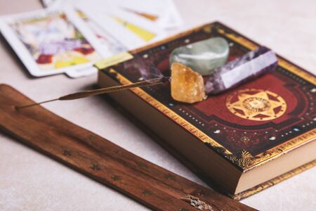 Incense and ritual accessories on a white background. Occultism concept. Fortune-telling cards.の写真素材