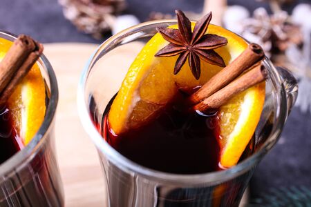 Red mulled wine with spices close-up on a black background.の写真素材
