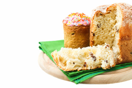 Sliced Easter cake with raisins isolated on white background.