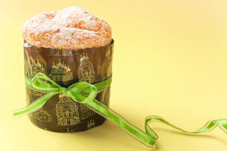 Easter cake with a green ribbon on an orange background.