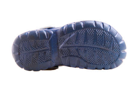 Children's blue rubber sandals isolated on a white background.の写真素材