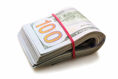Stack of one hundred dollar bills isolated on white background.