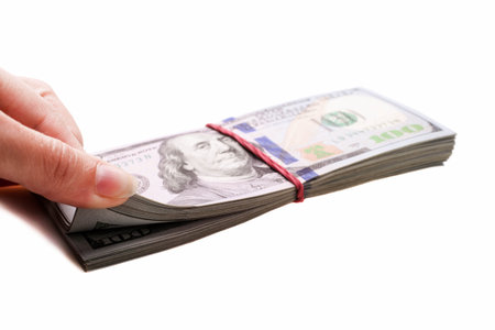 Stack of one hundred dollar bills isolated on white background.