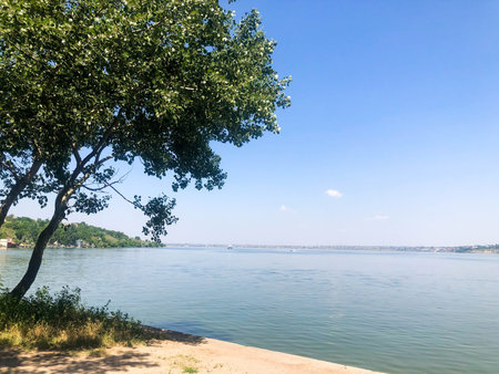A wide river against the backdrop of a clear blue sky. Landscape.