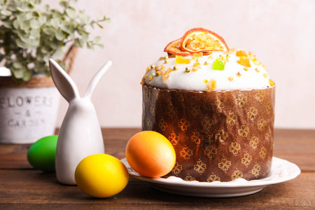 Easter cake with colored eggs and spring decor on a wooden brown background.