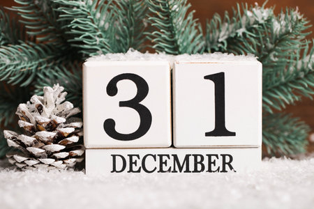 Perpetual calendar and fir branches on a snow. Christmas decor. Home decoration.の写真素材