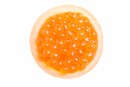 Red caviar of chum salmon in a tartlet isolated on white background.の写真素材