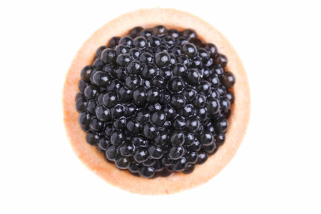 Black sturgeon caviar in a tartlet isolated on white background.の写真素材
