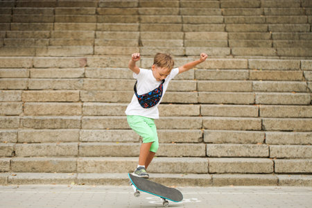 Boy is riding skateboard on the background of the stairs. An active sport.の写真素材
