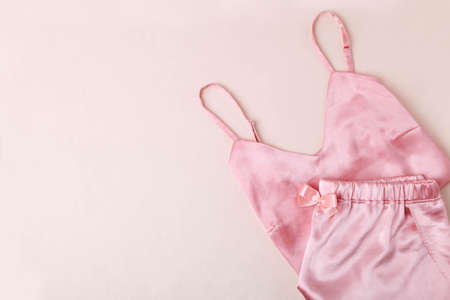 Pink satin female nightie on a beige background.の写真素材