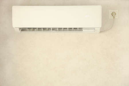 Included air conditioner in the room on the white wall.の写真素材