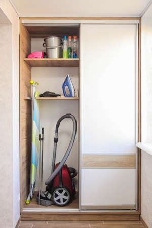 Storage of cleaning equipment in modern household closet.の写真素材