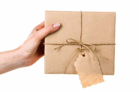 one gift in craft paper in woman's hand isolated on white background