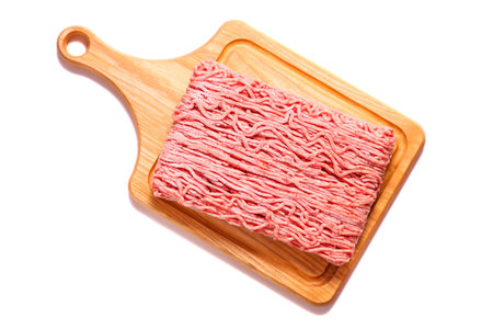 Frozen minced meat on cutting board isolated on white background.