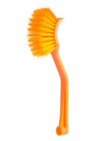 Orange brush with long handle isolated on white background.の写真素材