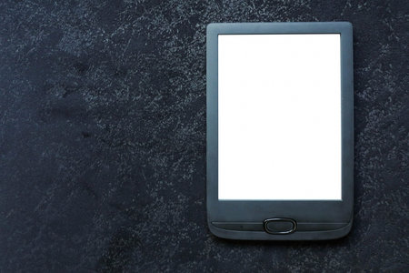 Electronic book on black velor background, top view.