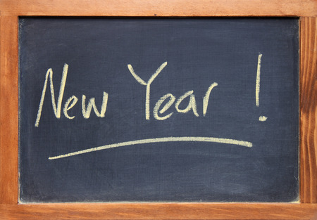 antique wooden framed chalkboard  blackboard with New Year written on itの写真素材