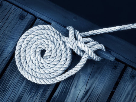 boat rope tied to dock securing boat