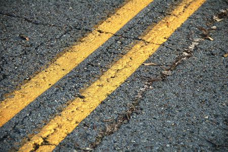 yellow no passing lines on roadの写真素材