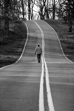 man walking on a country roadの写真素材