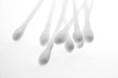 cotton swabs on plastic sticks against white background