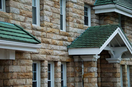 beautiful stone house with green shinglesの写真素材