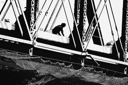 silhouetter of man  working on a bridgeの写真素材