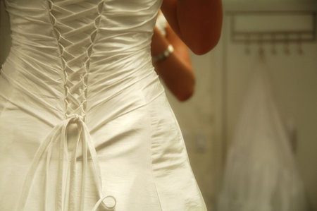 woman getting ready for her wedding day looking in mirror