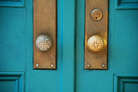 old double wooden doors with brass hardwareの写真素材