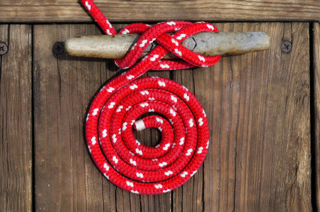 circle of red rope securing boat to dock