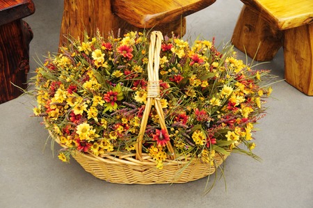 basket of beautiful orange and yellow flowers for the holidaysの写真素材