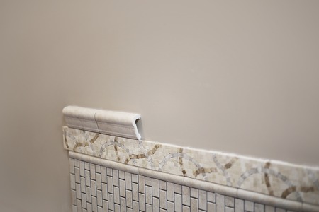 Pretty new ceramic tile being place in bathroom with unique design patternの写真素材