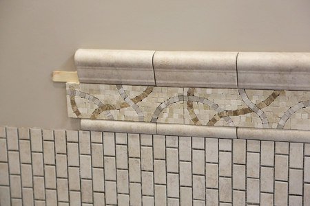 pretty new ceramic tile being placed in bathroom with unique design patternの写真素材