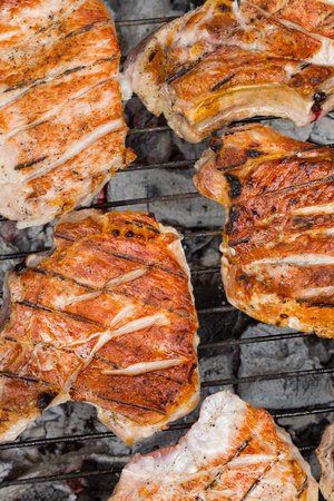 Grilled beef steak on the grill. grilling steaks on flaming grill and shot with selective focusの写真素材