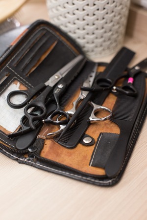 Scissors and on white rustic wooden background. Hairdresser salon concept. Haircut accessoriesの写真素材
