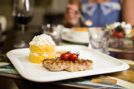 Grilled steak with baked vegetables and fresh rosemaryの写真素材