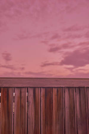 View of the sunset sky from behind the fence. high quality photoの写真素材