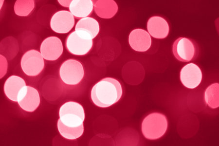 Viva Magenta lights bokeh background, Chrismas lights bokeh. Viva Magenta abstract background. Blurred and glowing lights. Viva Magenta bokeh lens effect from lighting spots.の写真素材