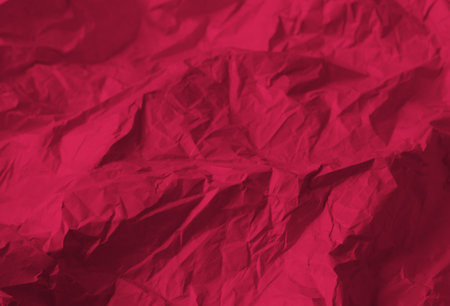 Crumpled paper Viva Magenta color of the year 2023. Texture crumpled paper for your design. Copy space. Viva Magenta color paper.の写真素材