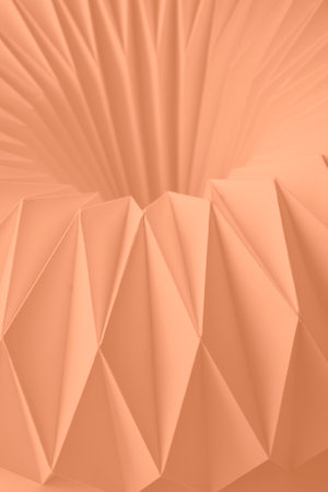 Macro Peach Fuzz color of paper folded in geometric shapes, three-dimensional effect, abstract background. Out of focus. Trendy color 2024 Peach Fuzzの写真素材